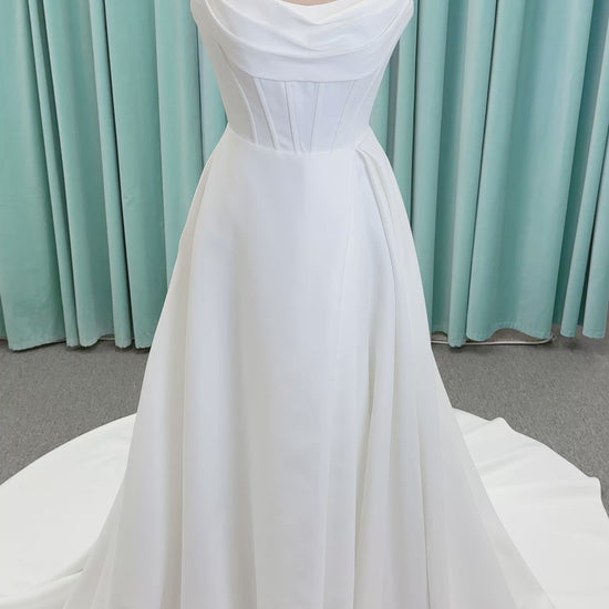 Morilee 15054 Pippa A-line wedding dress on mannequin with cowl neckline, corset bodice, petal satin skirt slit, and pockets