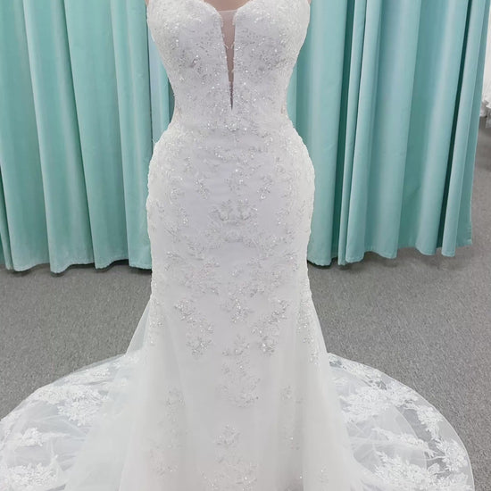 Moonlight Bridal J6996 Zira mermaid wedding dress on mannequin with strapless pointed sweetheart illusion neckline, side bodice cutouts, beaded lace appliques on shimmer net, drop waist, and chapel train with horsehair trim