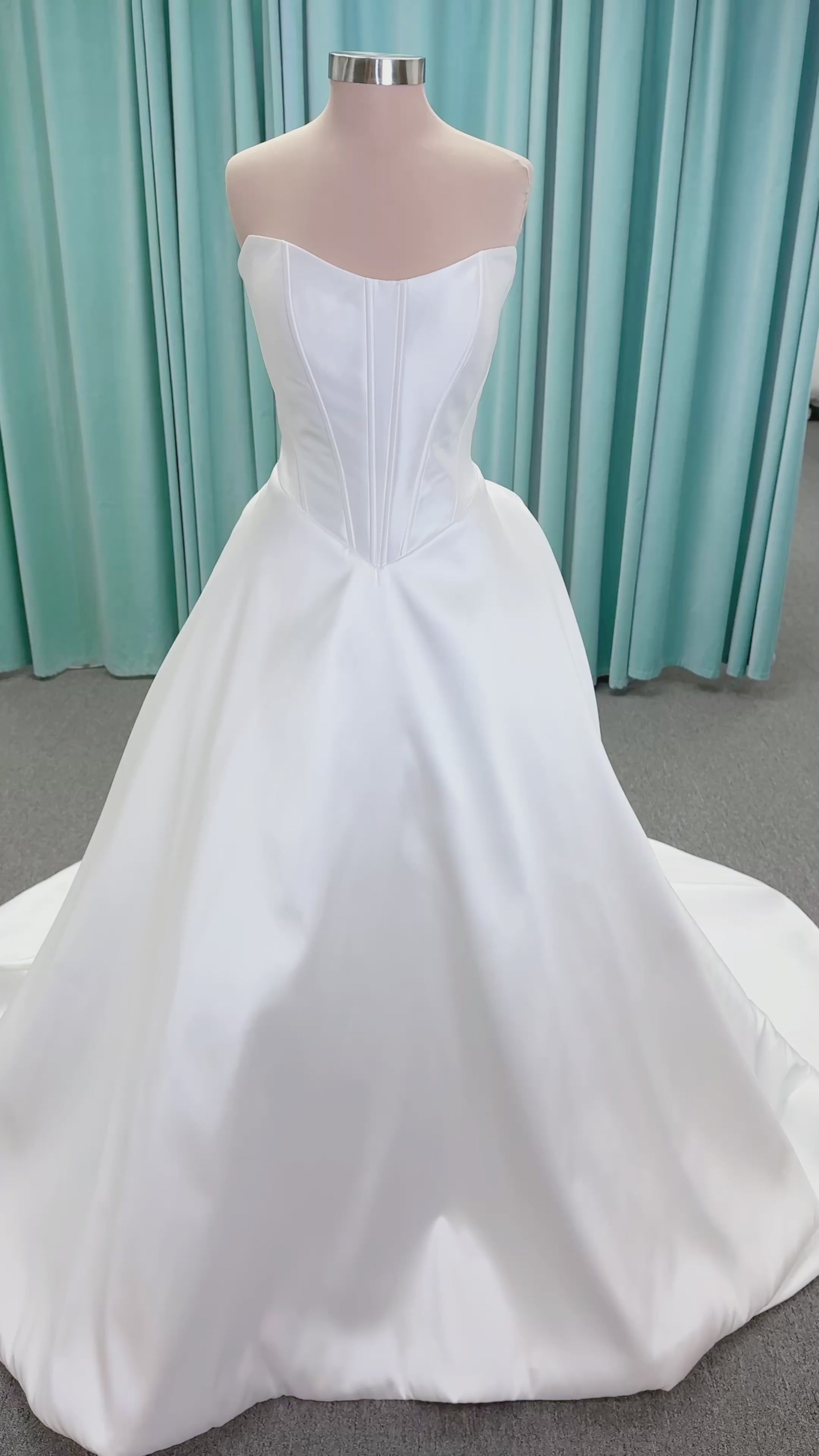 Randy Fenoli Idonna ball gown wedding dress on mannequin with strapless sweetheart neckline, structured mikado bodice, basque waist, covered back buttons, and side pockets