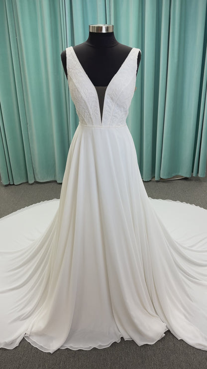 Martha My Dear ivory sleeveless V-neck A-line wedding dress on mannequin with geometric lace bodice panel and flowing chiffon skirt.
