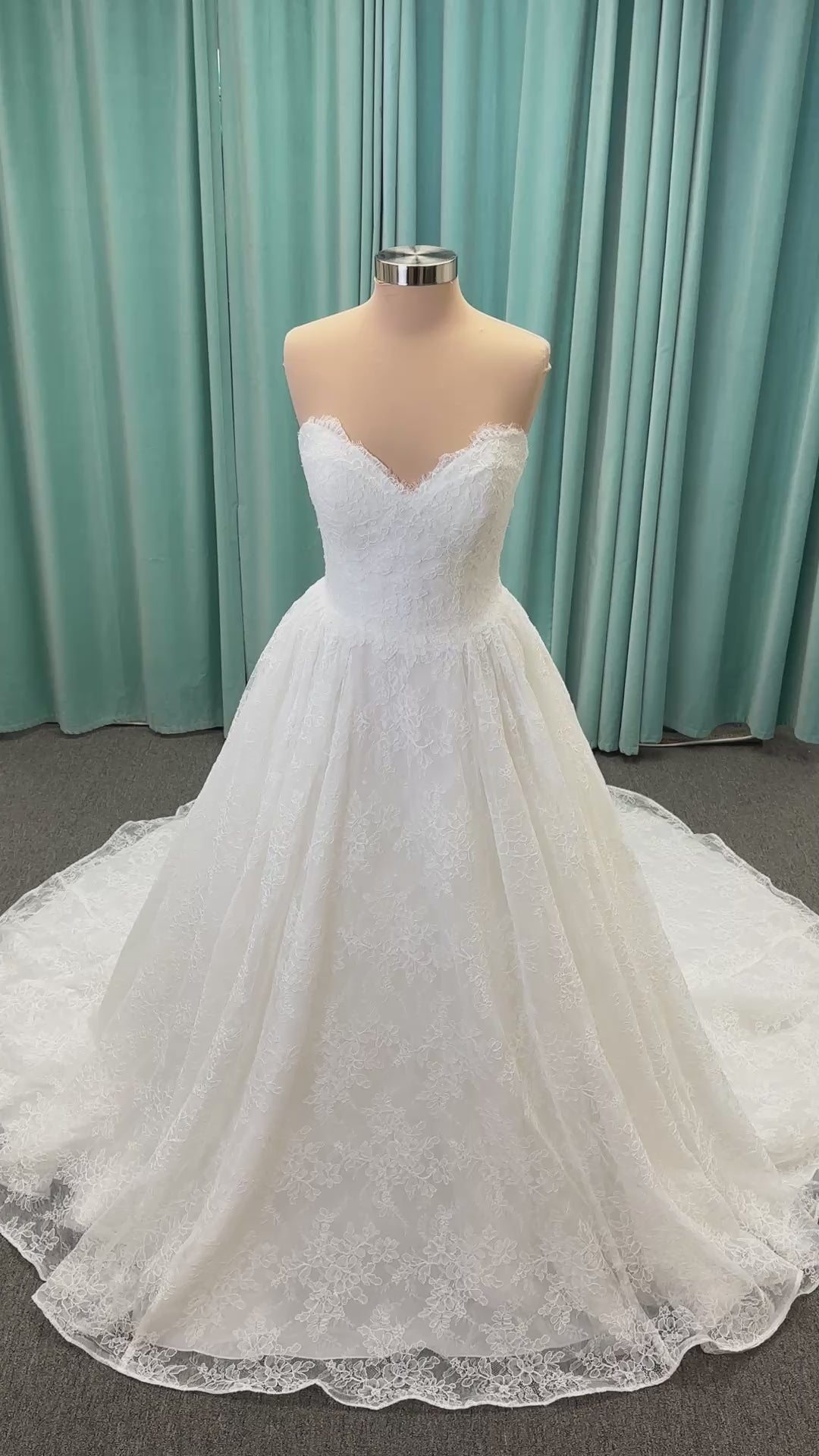 Moira ivory strapless sweetheart ballgown wedding dress on mannequin with sparkle lace detail and full voluminous skirt.

