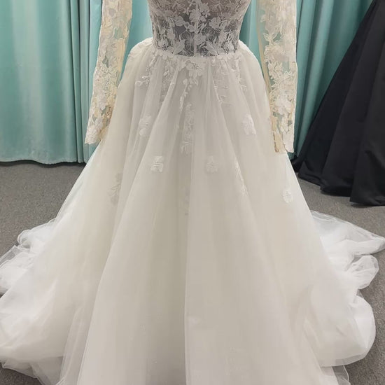 Stella York Style 8012 lace and tulle ballgown wedding dress with sheer sweetheart bodice, off-the-shoulder long lace sleeves, and full princess skirt