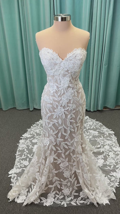 Morilee Santana wedding dress style 2739 featuring strapless sweetheart neckline, floral beaded lace, detachable long sleeves with bow streamers, and fit and flare silhouette