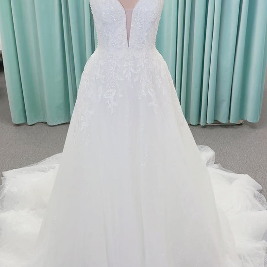 Morilee 1010021 Myrtha A-line wedding dress on mannequin with plunging V-neckline, sheer low scoop back, and glitter tulle lace applique
