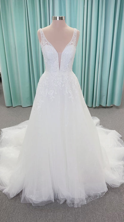 Morilee 1010021 Myrtha A-line wedding dress on mannequin with plunging V-neckline, sheer low scoop back, and glitter tulle lace applique