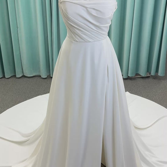 Essense of Australia D4225 ivory satin A-line wedding dress on mannequin with strapless scoop neckline, ruched bodice, and a front slit in the skirt.
