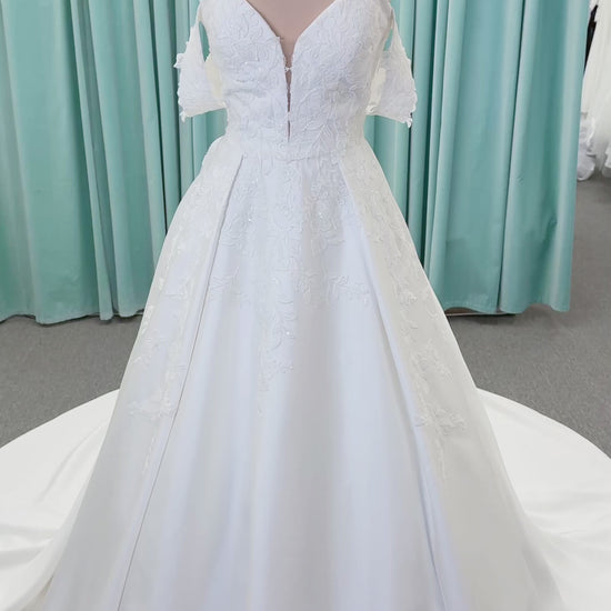 Morilee 2643 Rosemarie A-line wedding dress on mannequin with sweetheart plunging neckline, long sleeves, and frosted embroidered lace appliques