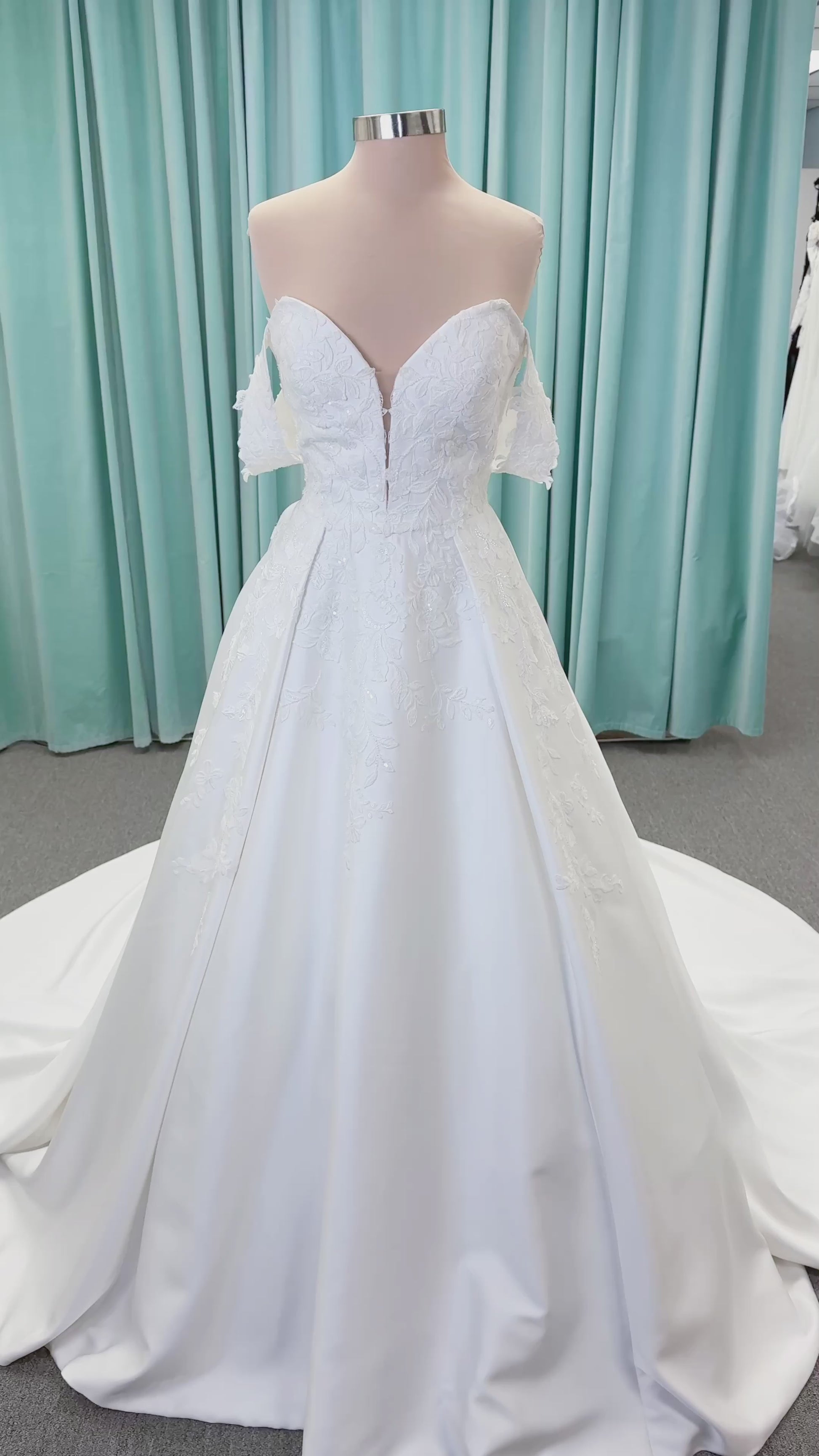 Morilee 2643 Rosemarie A-line wedding dress on mannequin with sweetheart plunging neckline, long sleeves, and frosted embroidered lace appliques