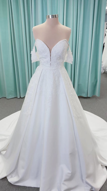 Morilee 2643 Rosemarie A-line wedding dress on mannequin with sweetheart plunging neckline, long sleeves, and frosted embroidered lace appliques