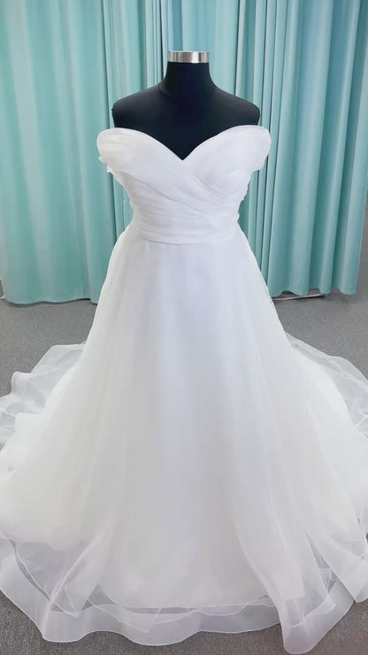 Morilee 3350 Evette ball gown wedding dress in draped organza with off-the-shoulder surplice bodice, horsehair-edged skirt, and covered buttons to hem.