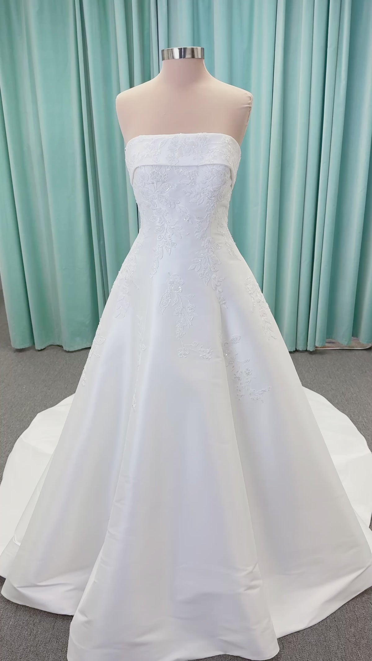 Morilee 1010037 Isadora A-line wedding dress on mannequin with strapless cuffed neckline, princess seams, and beaded Mikado lace