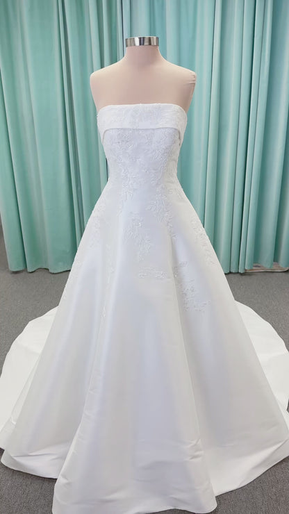 Morilee 1010037 Isadora A-line wedding dress on mannequin with strapless cuffed neckline, princess seams, and beaded Mikado lace