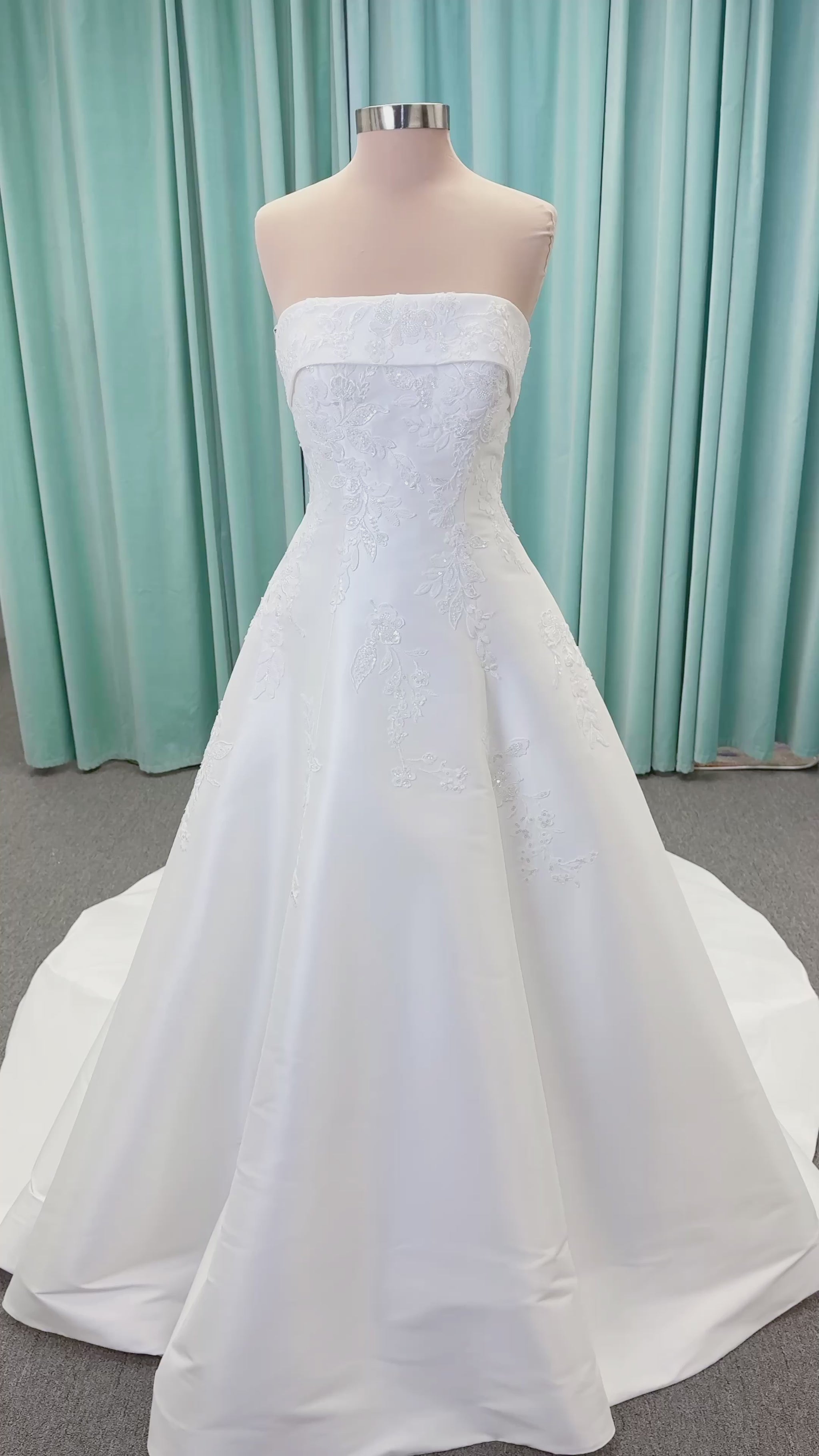 Morilee 1010037 Isadora A-line wedding dress on mannequin with strapless cuffed neckline, princess seams, and beaded Mikado lace