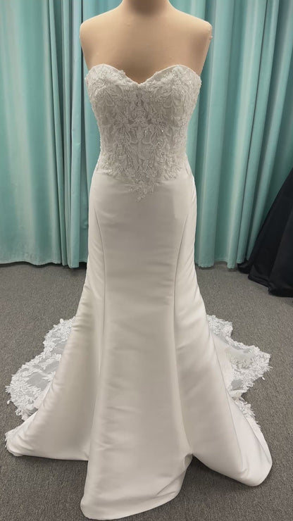 Strapless Mikado fit-and-flare wedding dress with corset bodice, exposed boning, lace detailing, and dramatic lace train by Stella York Style SY8163