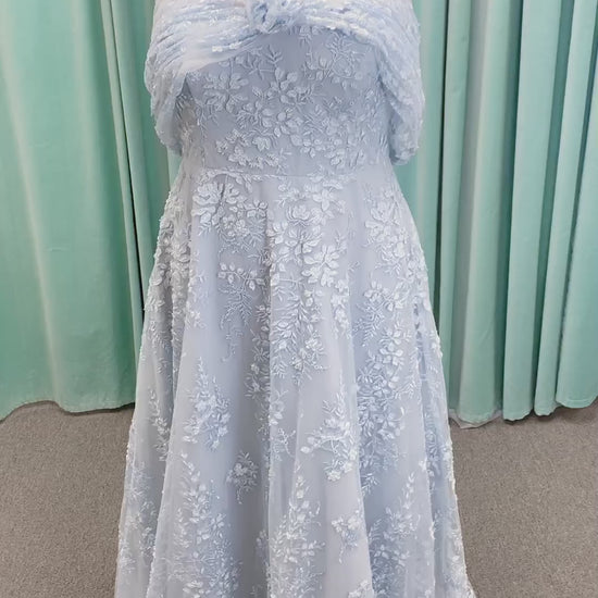 Morilee MLNY 73101 A-line mother of the bride dress on mannequin with strapless sweetheart neckline, detachable off-the-shoulder drape, 3D floral bodice, layered floral lace appliques, and full tulle skirt with pockets