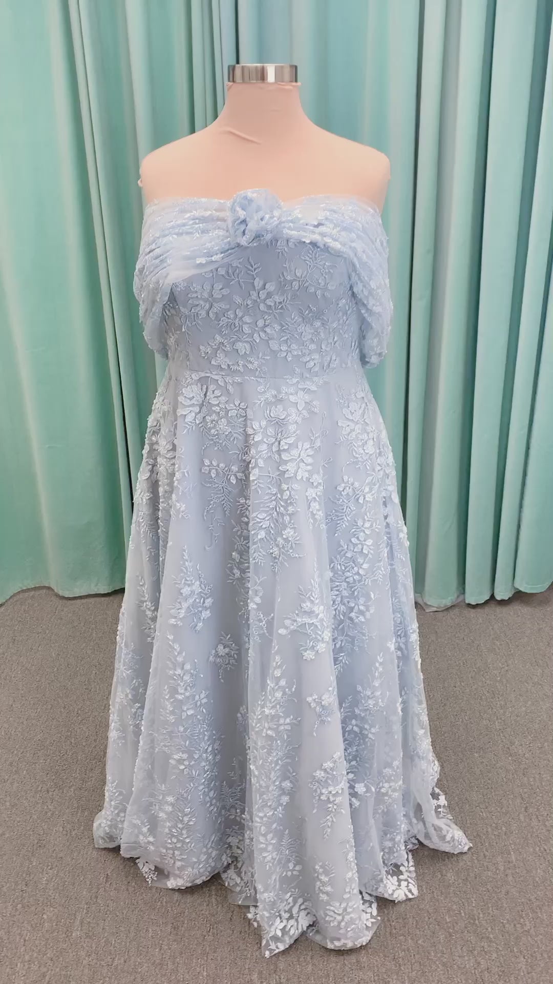 Morilee MLNY 73101 A-line mother of the bride dress on mannequin with strapless sweetheart neckline, detachable off-the-shoulder drape, 3D floral bodice, layered floral lace appliques, and full tulle skirt with pockets