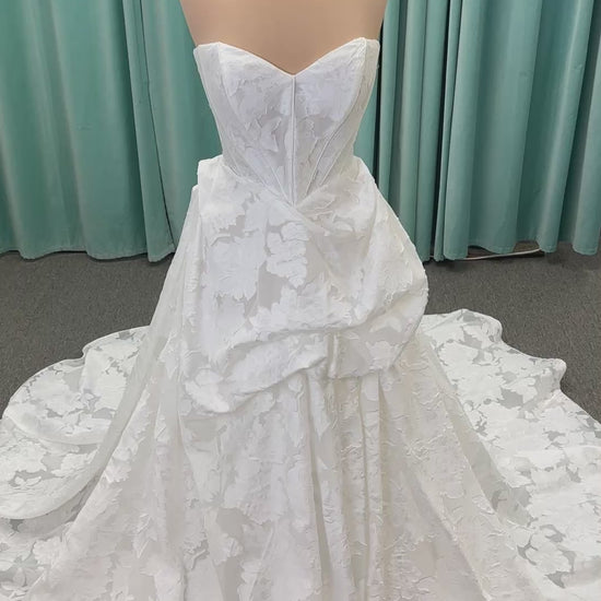 Palmer ivory strapless sweetheart A-line wedding dress on mannequin in jacquard fabric with a front thigh-high slit.
