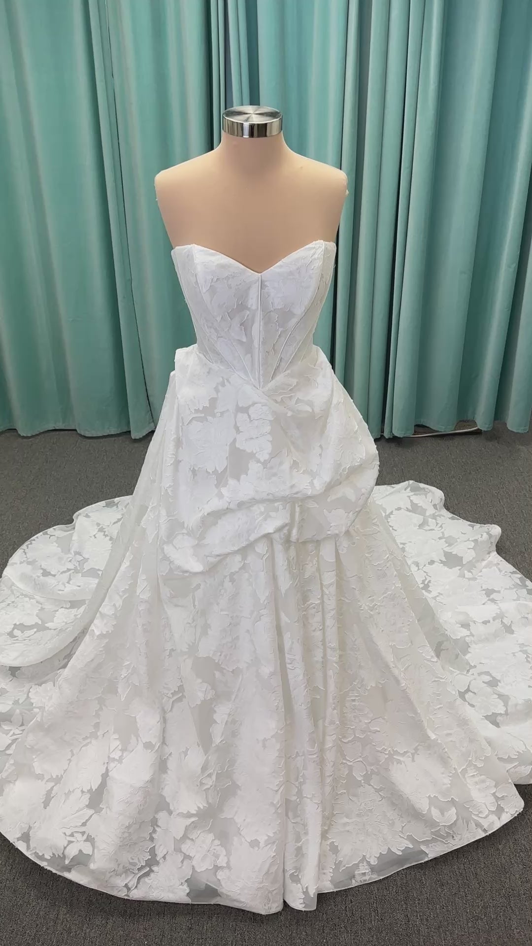 Palmer ivory strapless sweetheart A-line wedding dress on mannequin in jacquard fabric with a front thigh-high slit.
