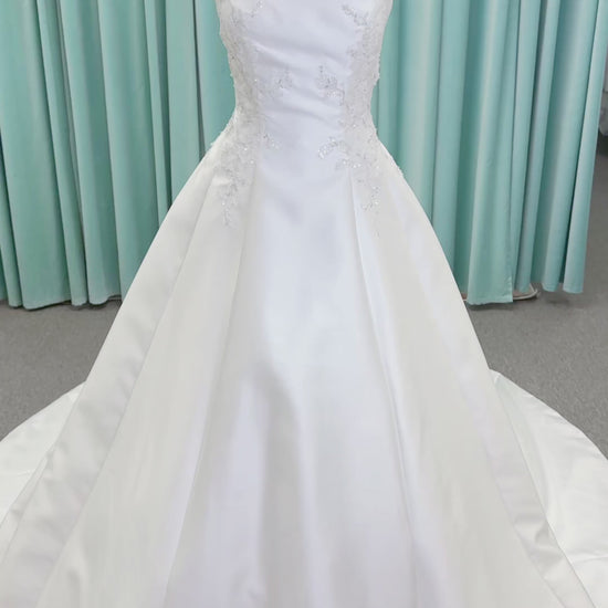 Morilee 1050018 Glissade A-line wedding dress on mannequin with high neckline, 3D floral lace appliques, satin, and beading