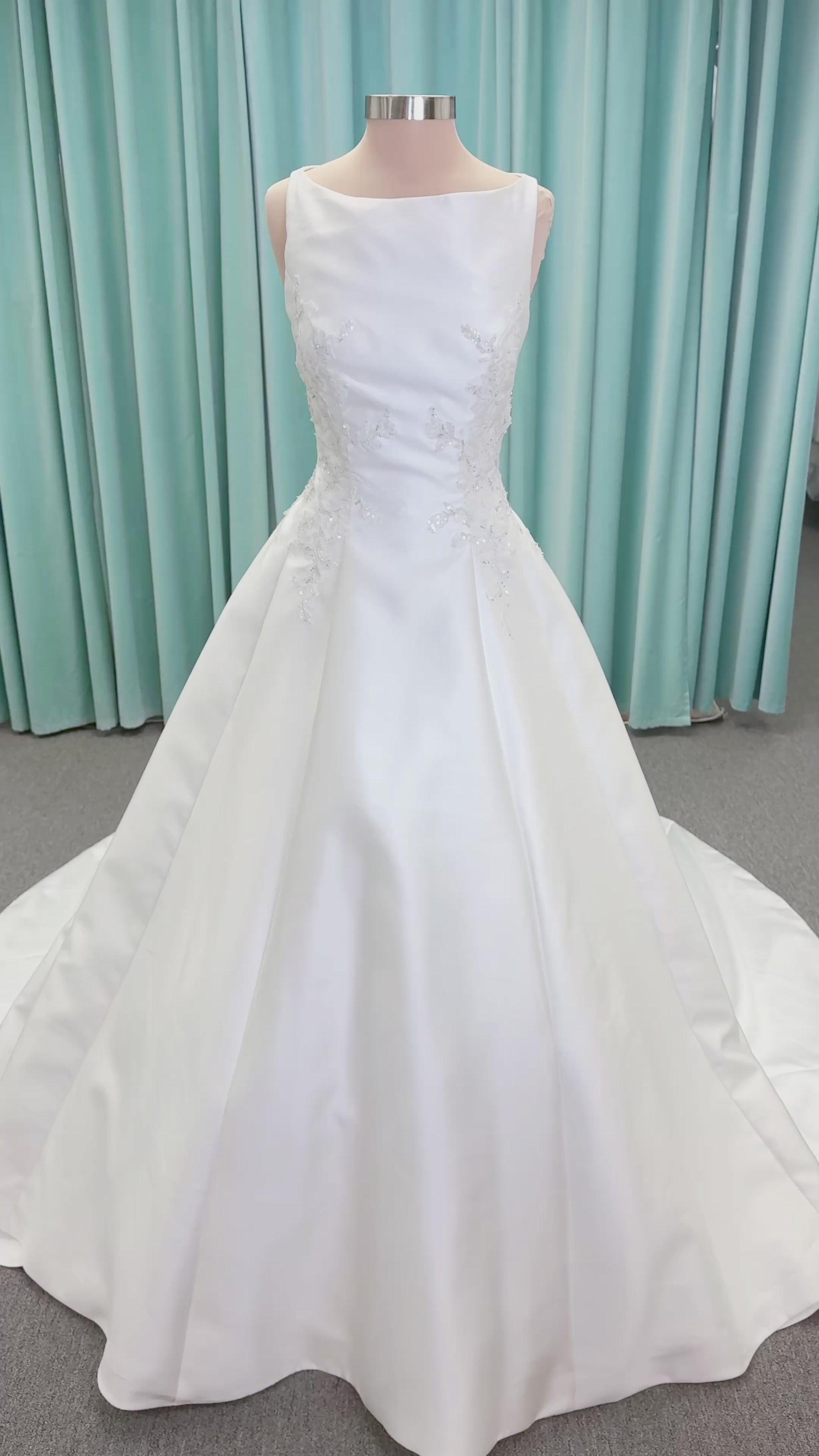 Morilee 1050018 Glissade A-line wedding dress on mannequin with high neckline, 3D floral lace appliques, satin, and beading