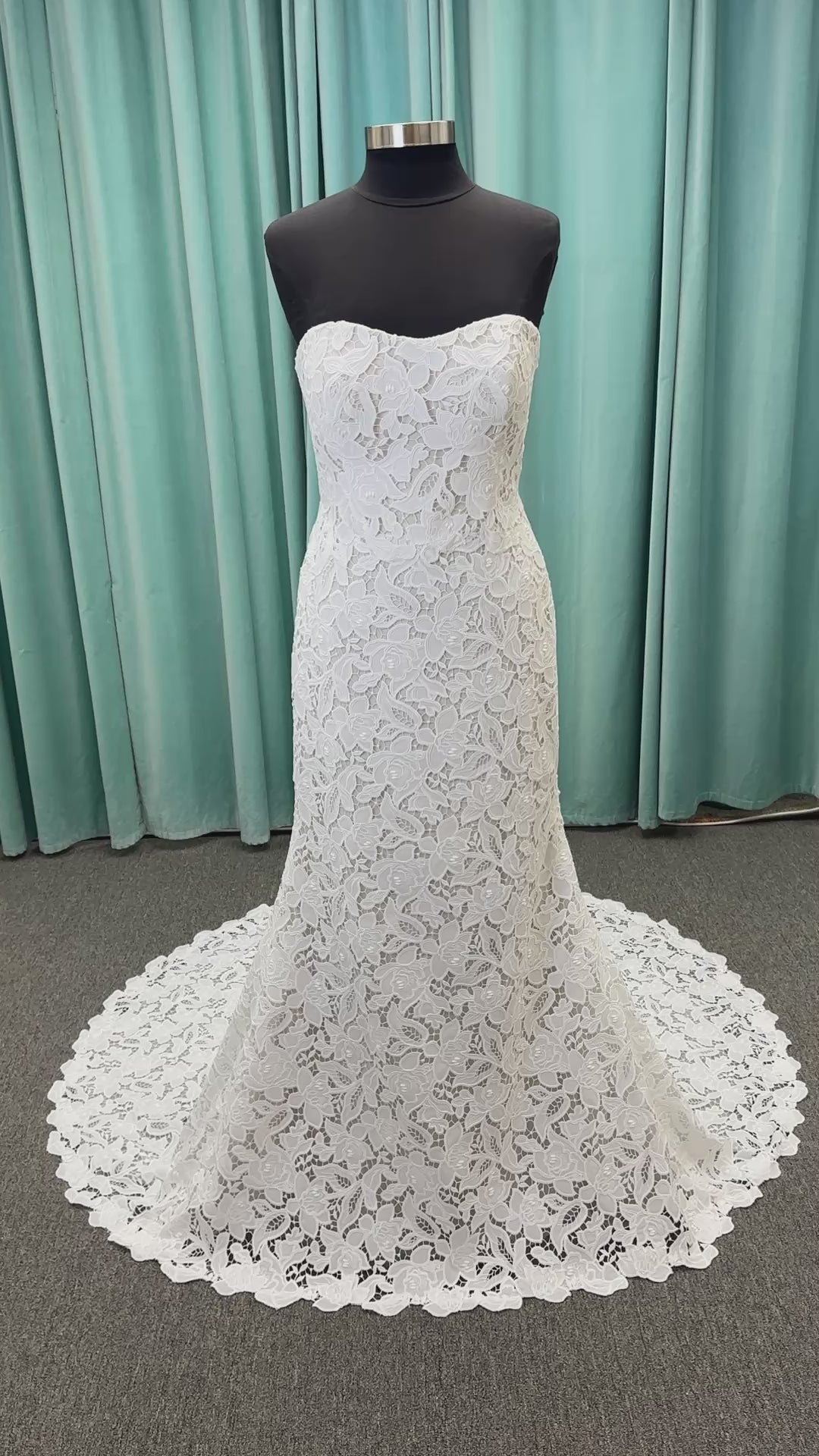 Patty ivory strapless sheath wedding dress on mannequin with sweetheart neckline and lace detail.
