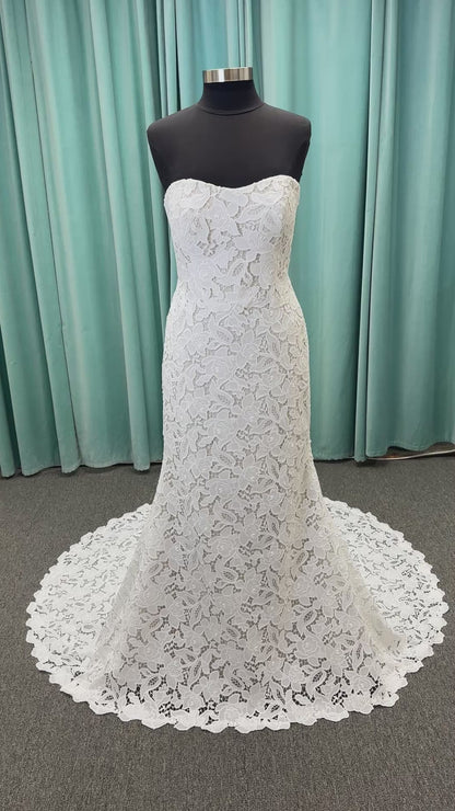 Patty ivory strapless sheath wedding dress on mannequin with sweetheart neckline and lace detail.
