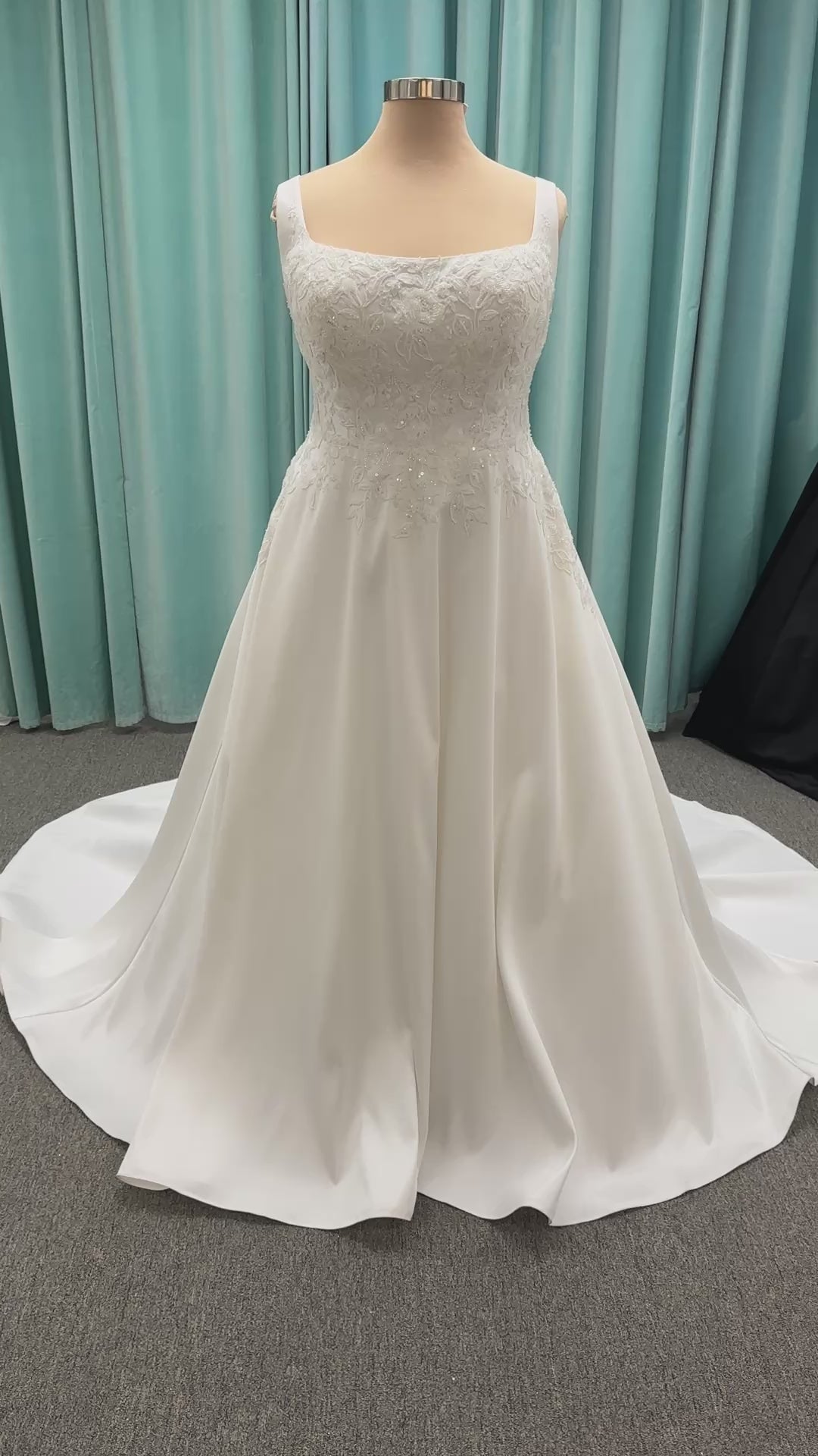 Plus size Stella York 7897 wedding dress in Mikado fabric with square neckline, lace bodice, side cutouts, and flowing A-line skirt with pockets