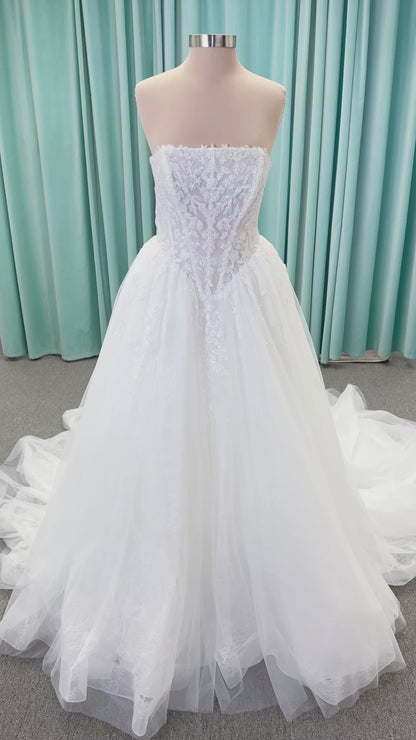 Morilee 2714 Seattle ballgown wedding dress on mannequin with crescent neckline, beaded embroidered lace, basque waist, and detachable illusion sleeves