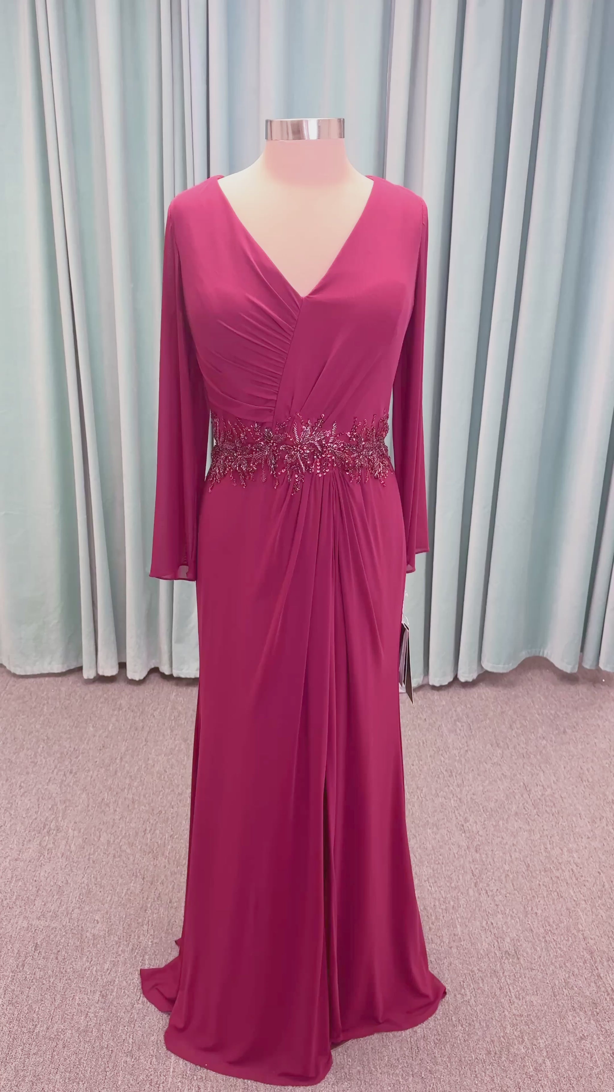 Morilee MLNY 73175 fit and flare mother of the bride dress on mannequin with draped V-neckline, long sleeves, beaded appliques, beaded waist, and slit skirt