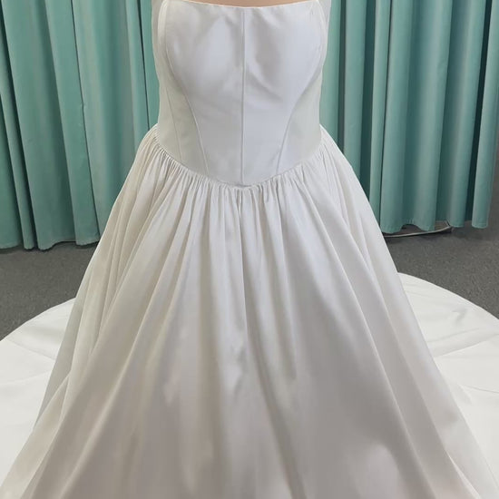 Essense of Australia D4145 ivory Mikado ballgown wedding dress on mannequin with strapless square neckline, basque waistline, and voluminous pleated skirt.
