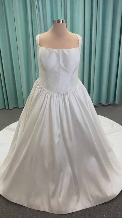 Essense of Australia D4145 ivory Mikado ballgown wedding dress on mannequin with strapless square neckline, basque waistline, and voluminous pleated skirt.
