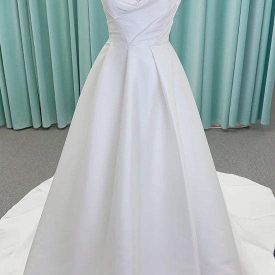 Morilee 1010001 Dove ballgown wedding dress on mannequin with strapless scoop neckline, lace peek-a-boo detail, and softly pleated skirt