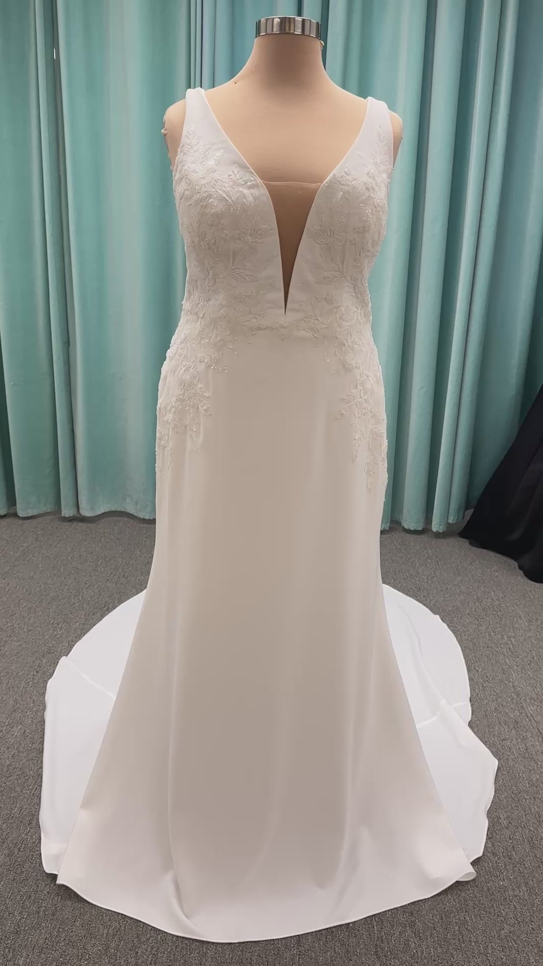 Stella York 7774 column sheath wedding dress with plunging neckline, lace appliqués, side cutouts, and crepe skirt with train