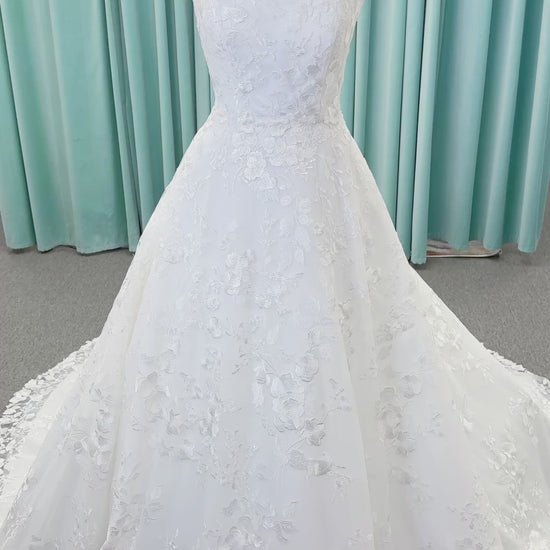 Morilee 2987 Callyso A-line wedding dress on mannequin with strapless tulle, floral threadwork, detachable puff sleeves, and flowing train
