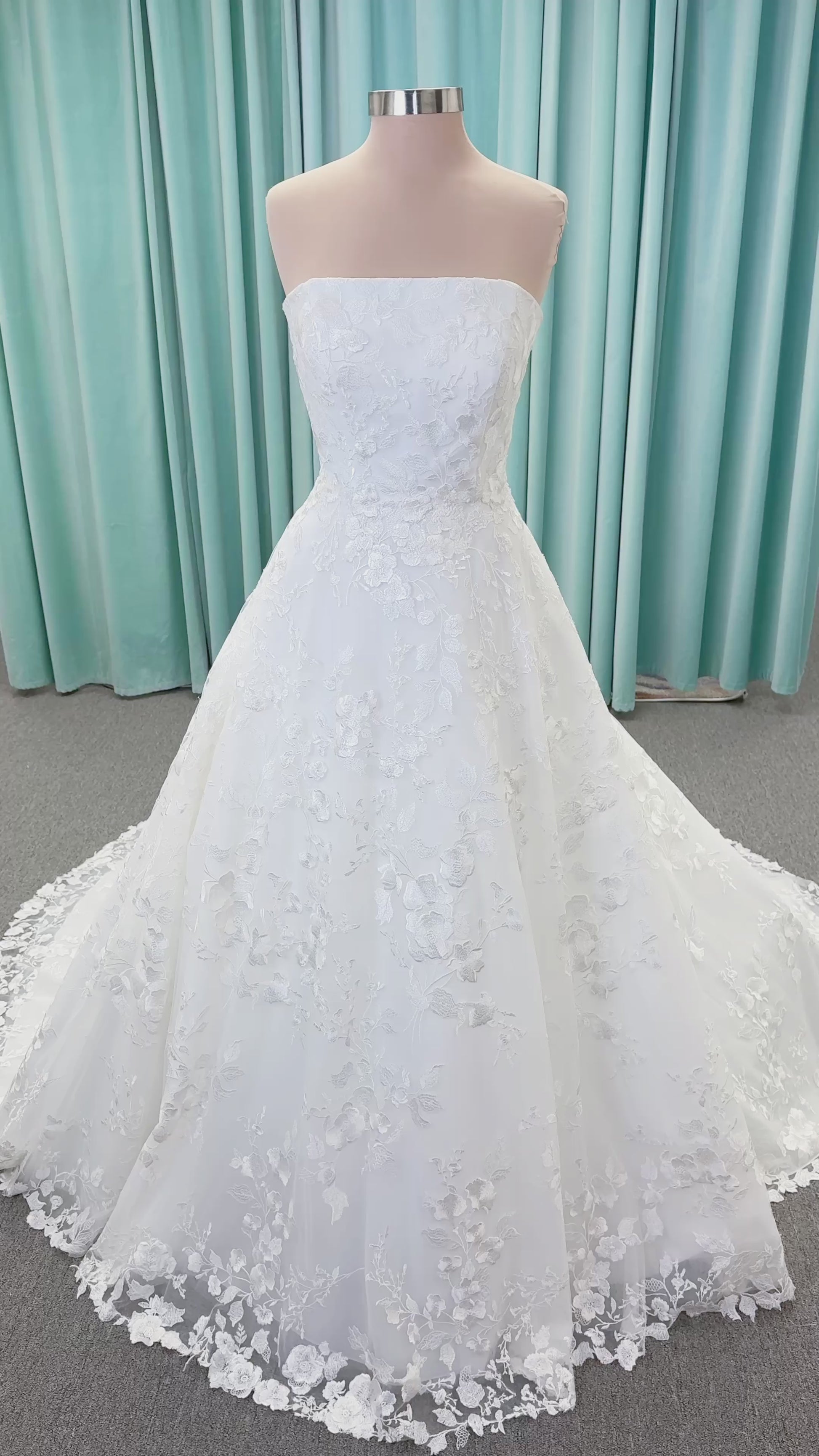 Morilee 2987 Callyso A-line wedding dress on mannequin with strapless tulle, floral threadwork, detachable puff sleeves, and flowing train