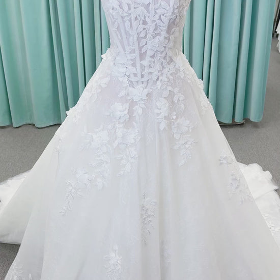 Morilee 1010024 Alina A-line wedding dress on mannequin with strapless basque waist, corset boning, Chantilly lace, and hand-cut taffeta flowers