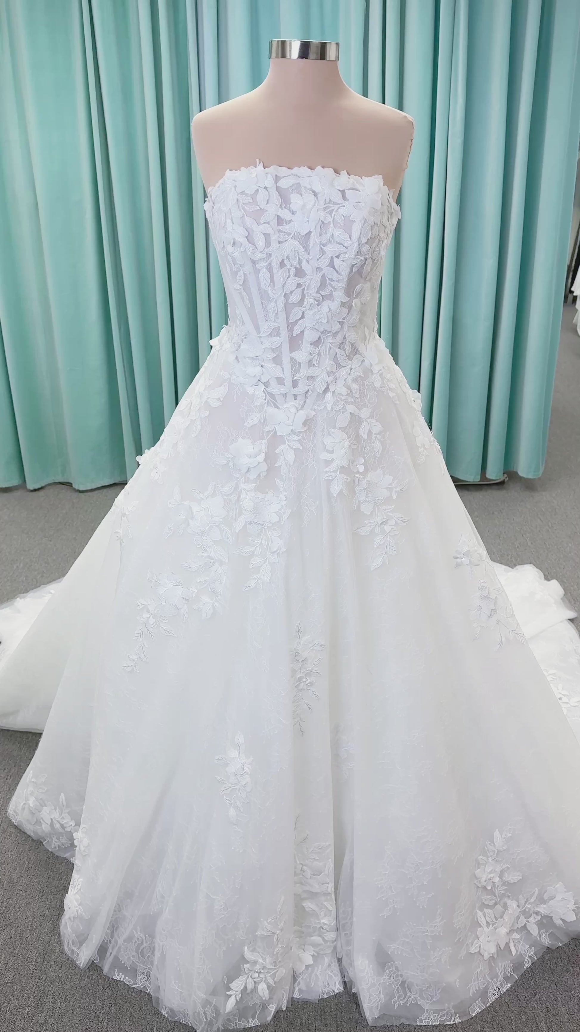 Morilee 1010024 Alina A-line wedding dress on mannequin with strapless basque waist, corset boning, Chantilly lace, and hand-cut taffeta flowers