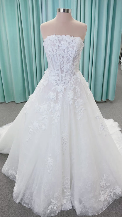 Morilee 1010024 Alina A-line wedding dress on mannequin with strapless basque waist, corset boning, Chantilly lace, and hand-cut taffeta flowers