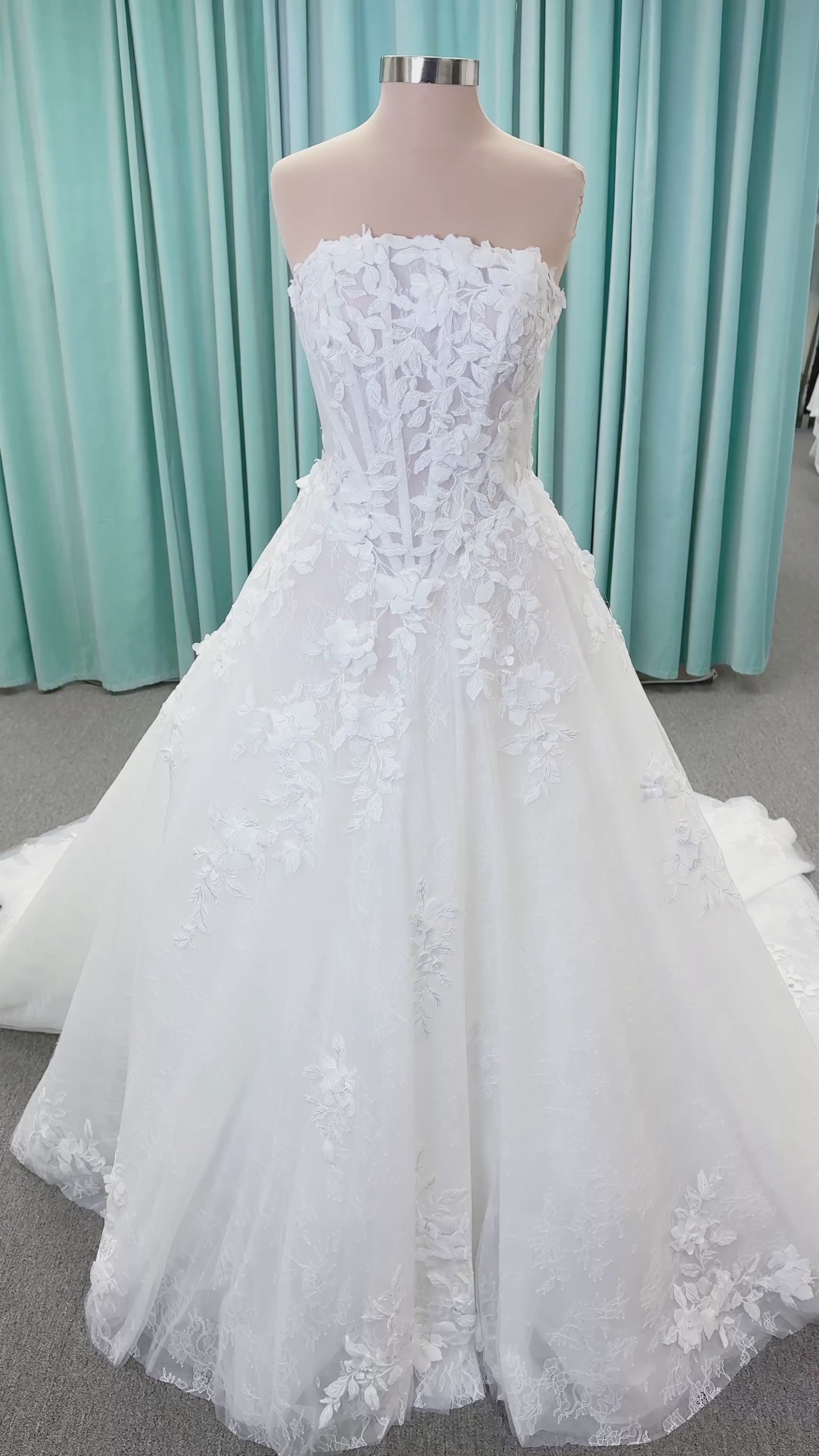 Morilee 1010024 Alina A-line wedding dress on mannequin with strapless basque waist, corset boning, Chantilly lace, and hand-cut taffeta flowers