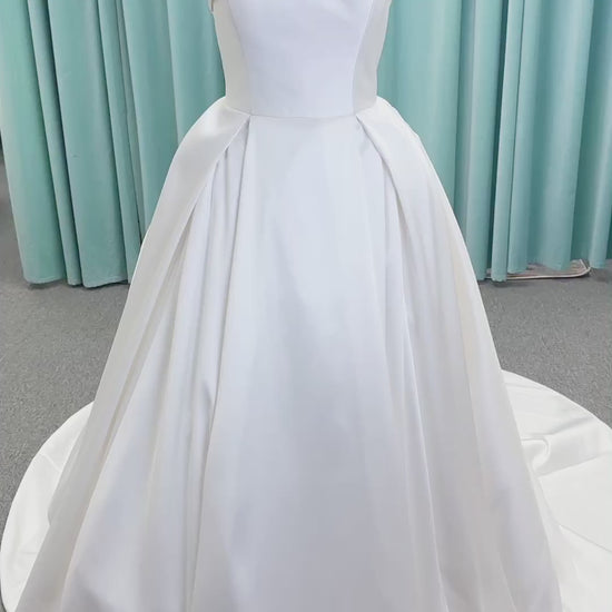 Morilee 1050011 Allegro A-line wedding dress on mannequin with strapless straight neckline, Mikado fabric, box-pleated skirt, and detachable fold-over bow