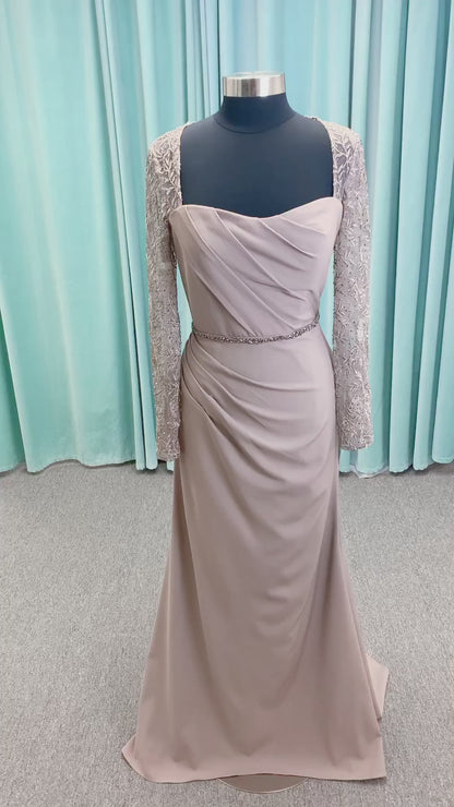 Morilee MLNY 73160 sheath mother of the bride dress on mannequin with modified sweetheart neckline, draped crepe bodice, sheer illusion long sleeves with lace applique, detachable beaded belt, and keyhole back