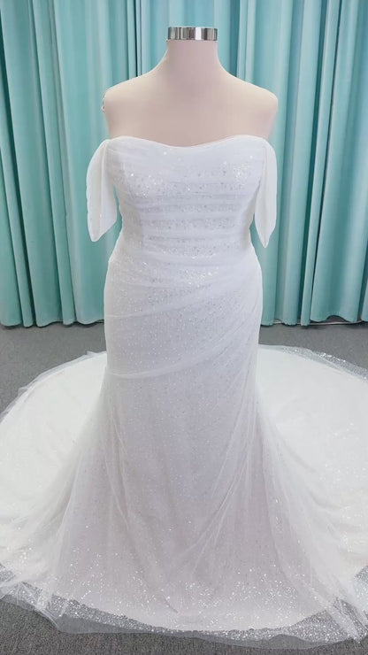 Morilee 3393 Lyrica fit and flare wedding dress in allover beaded net with draped tulle overlay, lace-up corset back, and detachable draped sleeves.