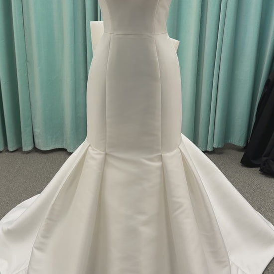 Modest Mikado fit-and-flare wedding dress with square neckline, low scoop back, and dramatic detachable bow train