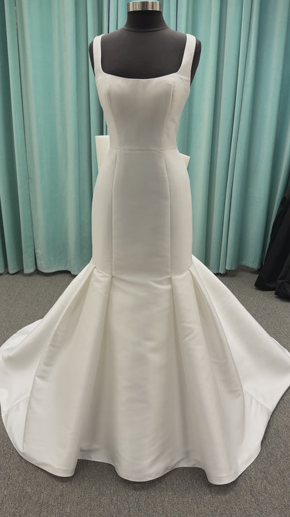 Modest Mikado fit-and-flare wedding dress with square neckline, low scoop back, and dramatic detachable bow train