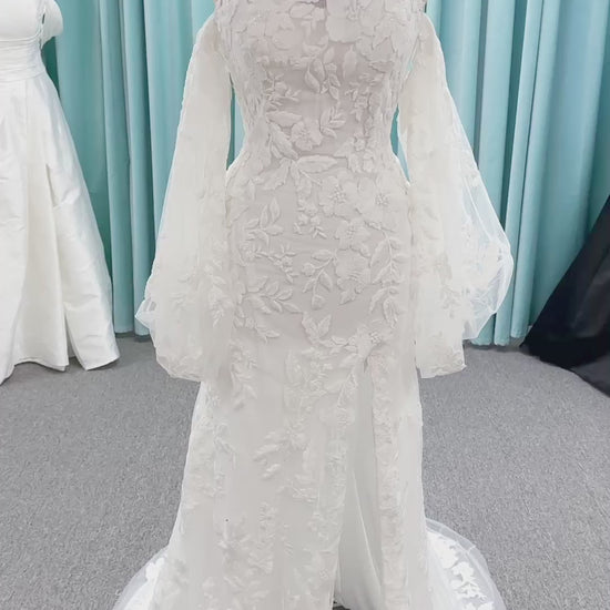 Morilee 2936 Kali fit and flare wedding dress on mannequin with high neckline, threadwork floral appliqued tulle, and detachable organza bow blouson sleeves