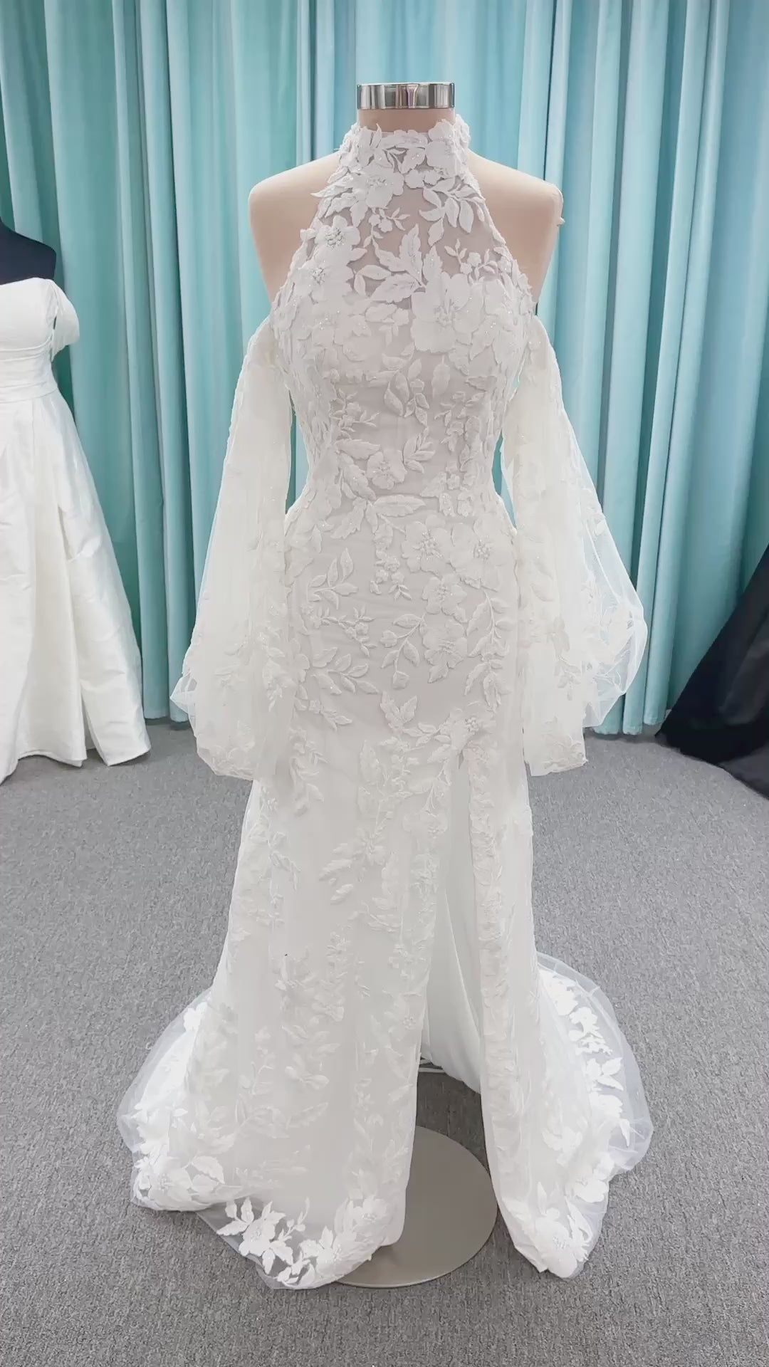 Morilee 2936 Kali fit and flare wedding dress on mannequin with high neckline, threadwork floral appliqued tulle, and detachable organza bow blouson sleeves